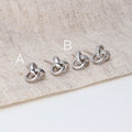 Flatlay view of Love Knot Stud Earrings in Sterling Silver, Yellow Gold Flashed