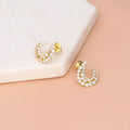 Flatlay view of Cluster Wrap CZ Stud Earrings in Sterling Silver, Yellow Gold Flashed