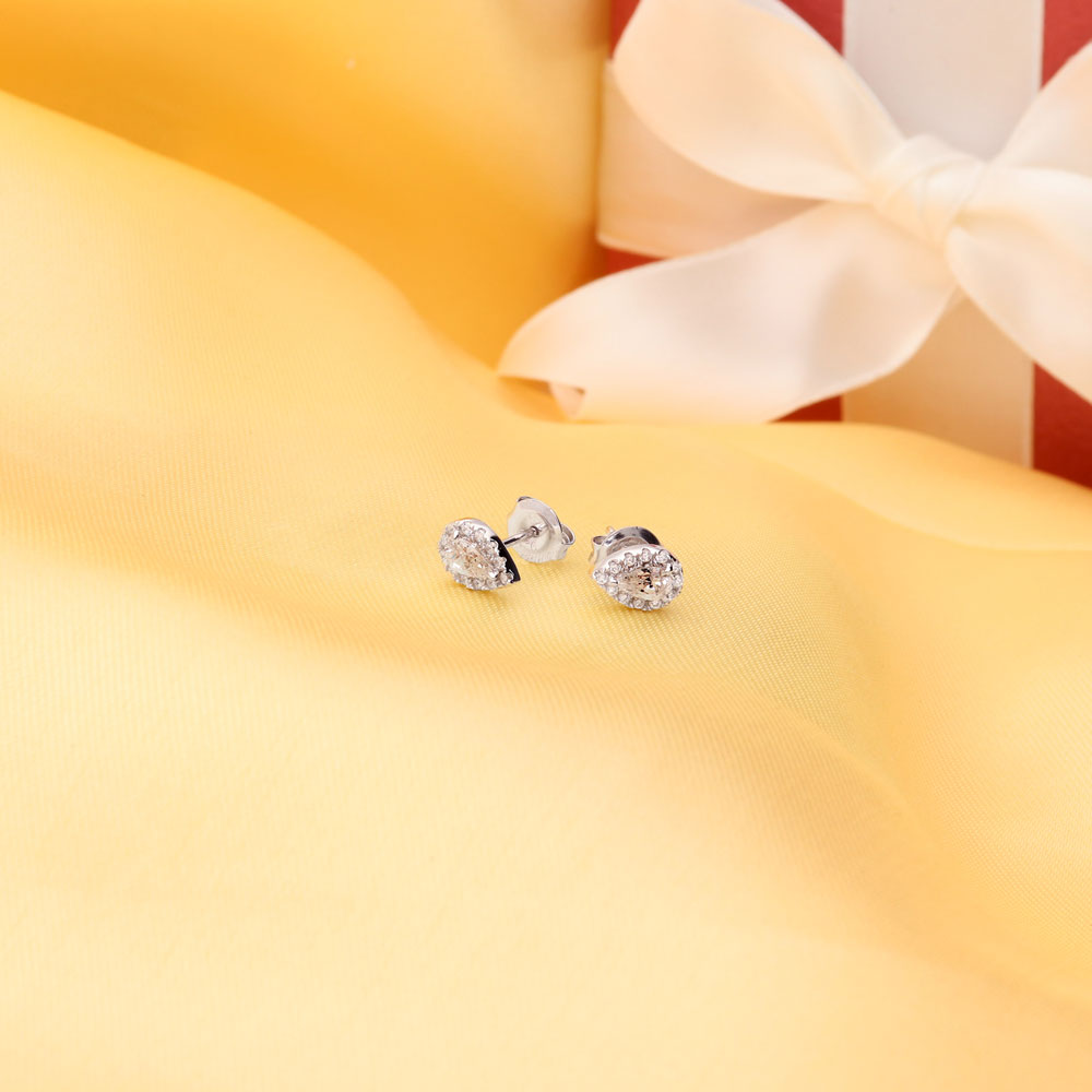 Flatlay view of Halo Pear CZ Stud Earrings in Sterling Silver, Clear Color