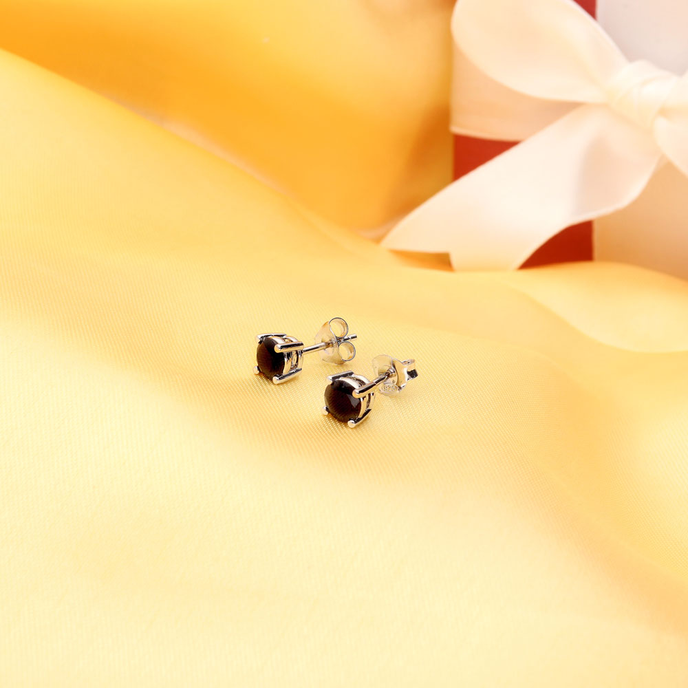 Flatlay view of Solitaire Black CZ Stud Earrings in Sterling Silver, 6mm