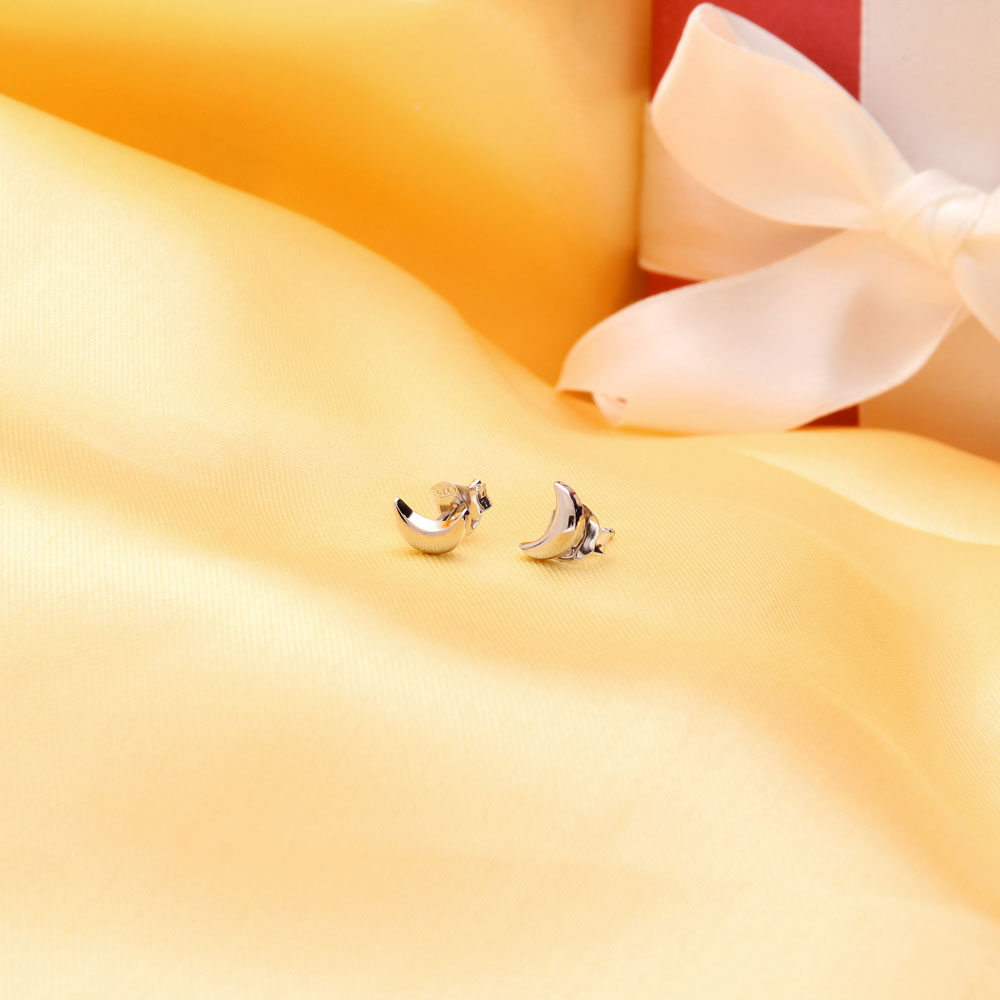 Flatlay view of Crescent Moon Cartilage Stud Earrings in Sterling Silver, Yellow Gold Flashed