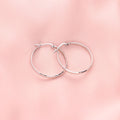 Flatlay view of Medium Hoop Earrings in Sterling Silver 1.2 inch