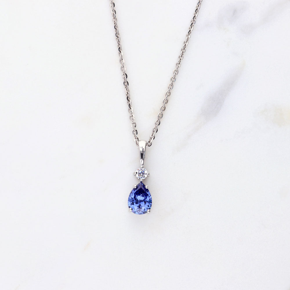 Flatlay view of Solitaire Pear Necklace in Sterling Silver 1ct, Tanzanite Color