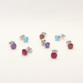 Flatlay view of Solitaire CZ Stud Earrings in Sterling Silver 1.6ct, Garnet Color