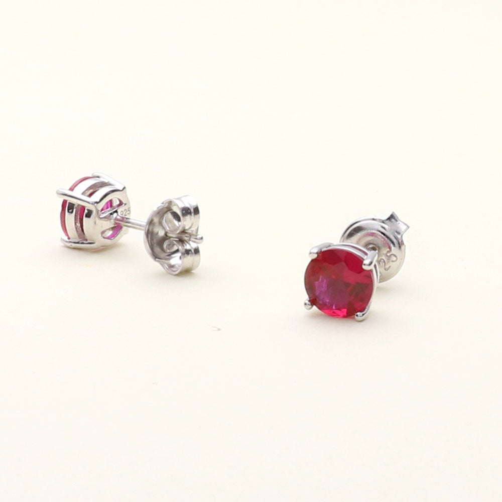 Flatlay view of Solitaire CZ Stud Earrings in Sterling Silver 1.6ct, Garnet Color