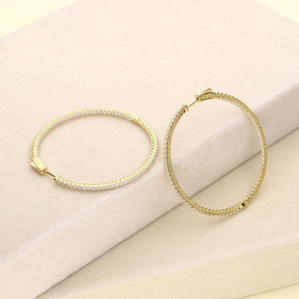 Flatlay view of CZ Large Inside-Out Hoop Earrings in Sterling Silver 2 inch, Yellow Gold Flashed