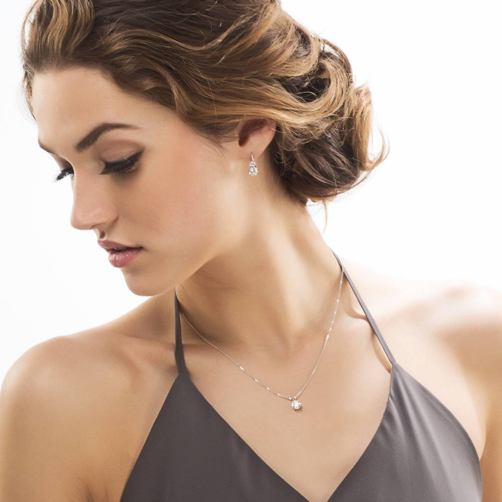 Model wearing 2-Stone CZ Leverback Earrings in Sterling Silver, Yellow Gold Flashed