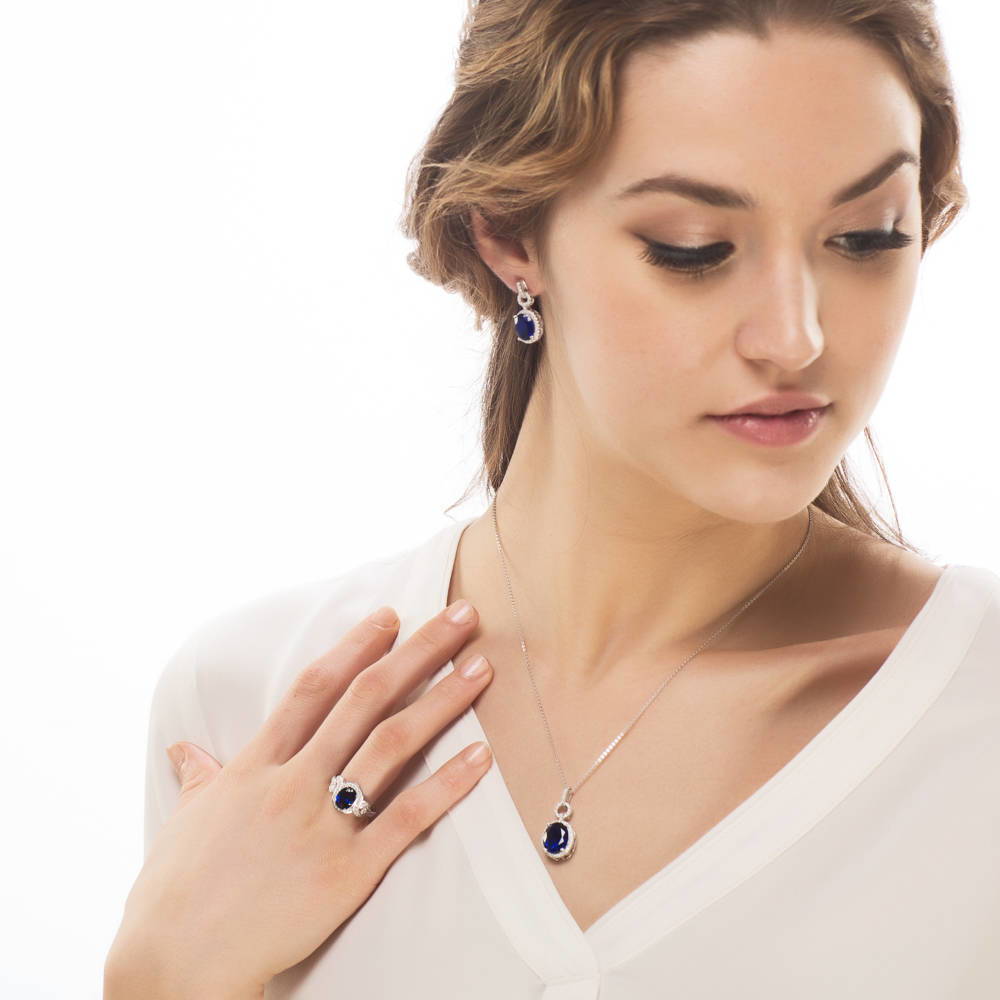 Model wearing Halo Sapphire-Blue Oval CZ Earrings in Sterling Silver, 2 of 2