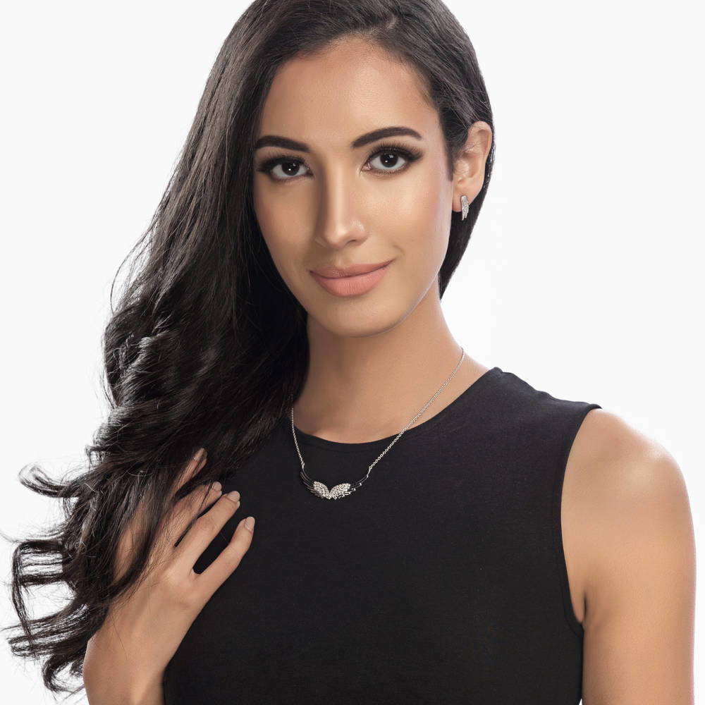 Model wearing Angel Wings CZ Stud Earrings in Sterling Silver, 2 of 3