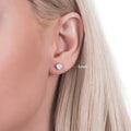 Model wearing Solitaire Cushion CZ Stud Earrings in Sterling Silver, 5mm