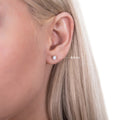 Model wearing Solitaire CZ Stud Earrings in Sterling Silver, 4mm