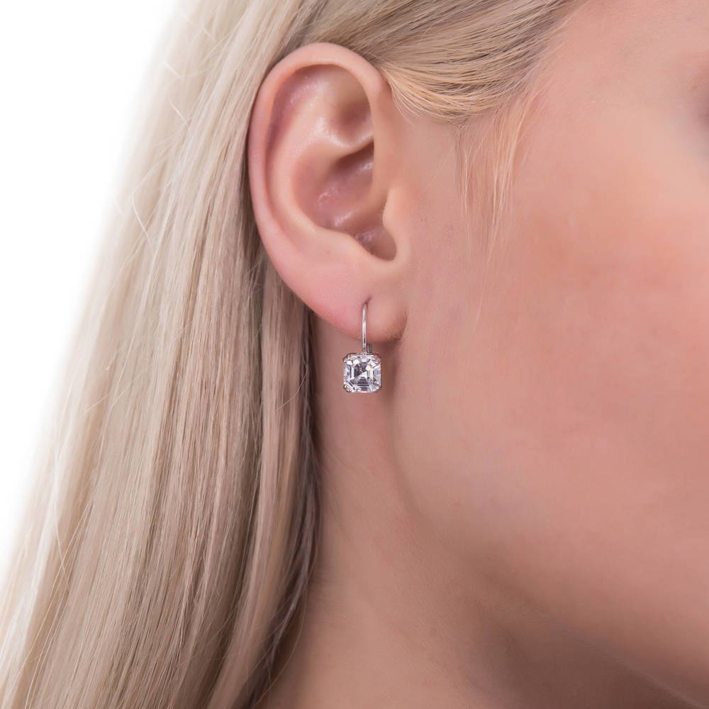 Model wearing Solitaire 4ct Asscher CZ Leverback Earrings in Sterling Silver, 2 of 3