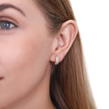 Model wearing Dome CZ Small Huggie Earrings in Sterling Silver 0.5 inch, Yellow Gold Flashed