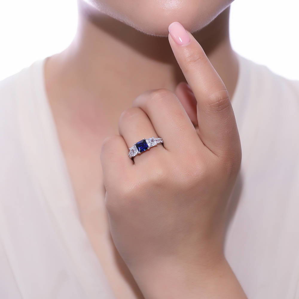 Model wearing 3-Stone Sapphire-Blue Princess CZ Ring Set in Sterling Silver, 6 of 8