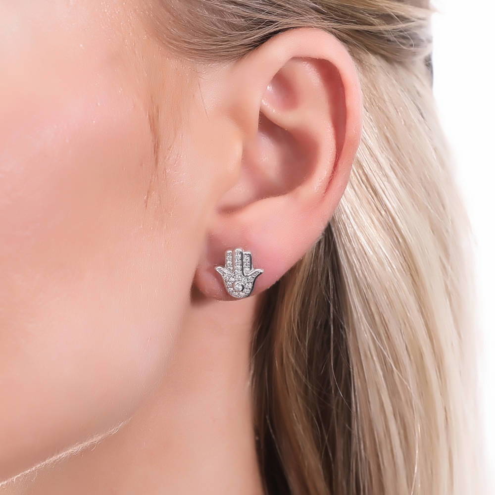 Model wearing Hamsa Hand CZ Stud Earrings in Sterling Silver, 2 of 7