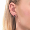 Model wearing Love Knot Stud Earrings in Sterling Silver, Yellow Gold Flashed