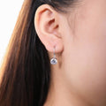 Model wearing Solitaire CZ Leverback Earrings in Sterling Silver, Rhodium Plated / 7mm
