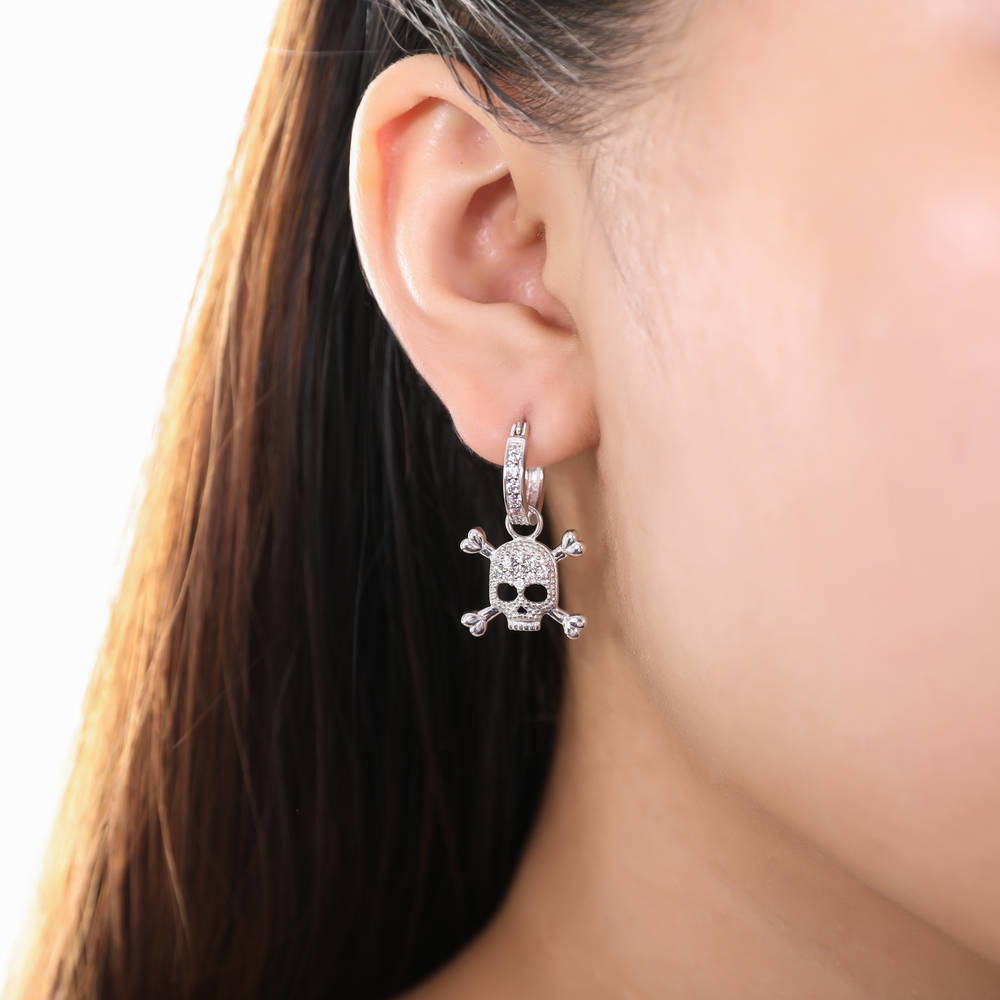 Model wearing Skull Bones CZ Earrings in Sterling Silver, 3 of 6