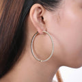 Model wearing CZ Large Inside-Out Hoop Earrings in Sterling Silver 2.2 inch, Rose Gold Flashed