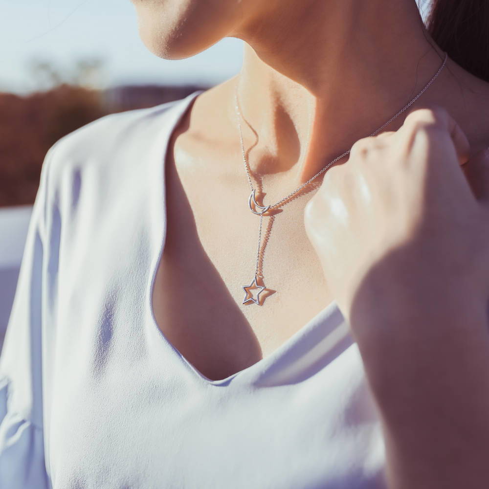 Model wearing Star Crescent Moon Lariat Necklace in Sterling Silver, 2 of 5
