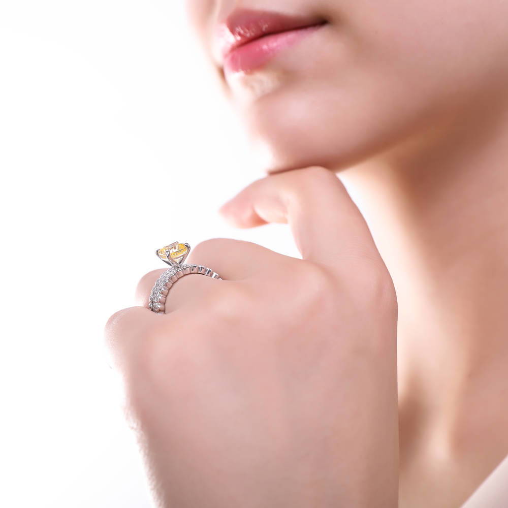 Model wearing Solitaire 3ct Canary Yellow Cushion CZ Ring in Sterling Silver, 17 of 18