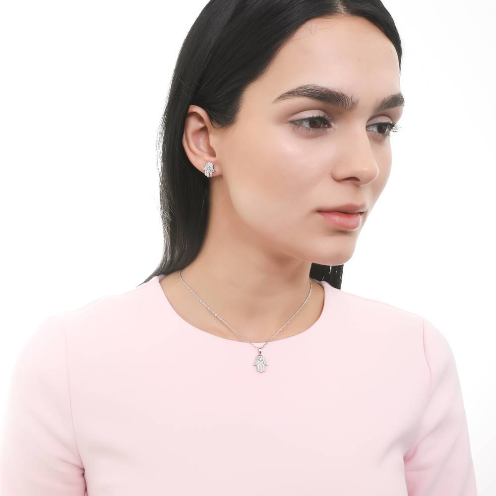 Model wearing Hamsa Hand CZ Stud Earrings in Sterling Silver, 6 of 7