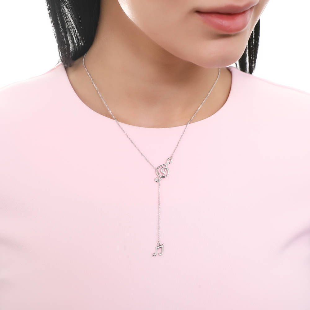 Model wearing Treble Clef Music Note Lariat Necklace in Sterling Silver, 6 of 9