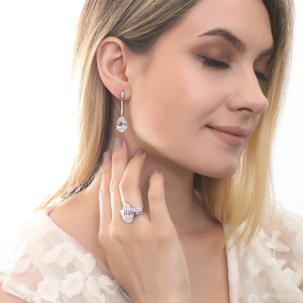 Model wearing Solitaire 11.4ct Pear CZ Earrings in Sterling Silver, 3 of 4