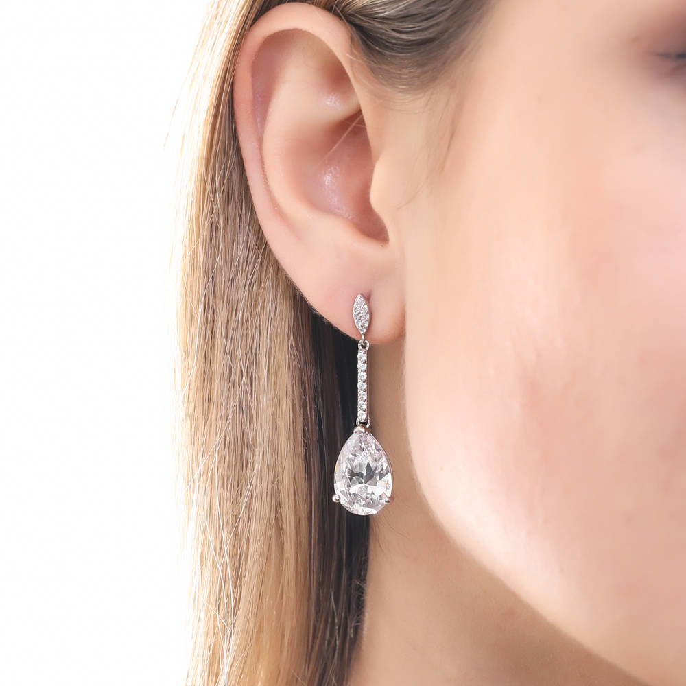 Model wearing Solitaire 11.4ct Pear CZ Earrings in Sterling Silver, 2 of 4