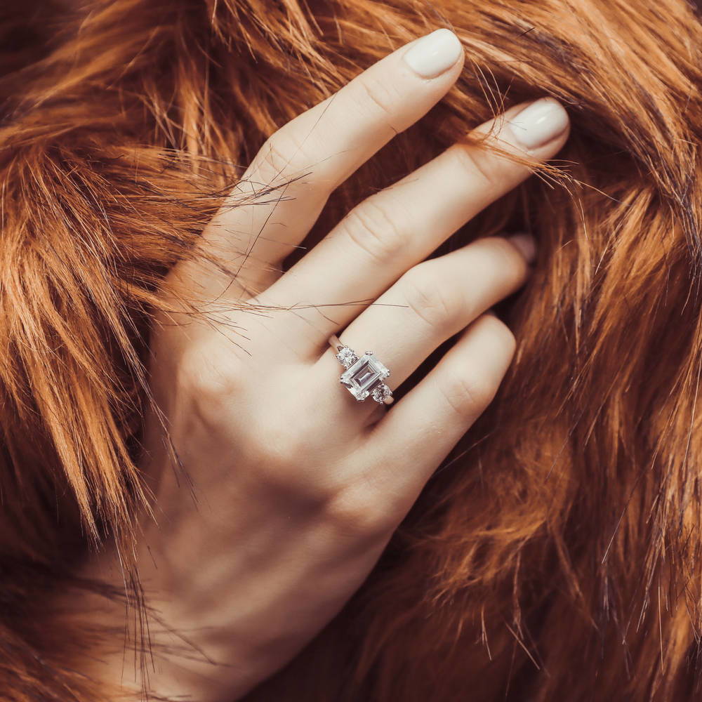 Model wearing 3-Stone 2.6ct Emerald Cut CZ Ring in Sterling Silver, 9 of 13