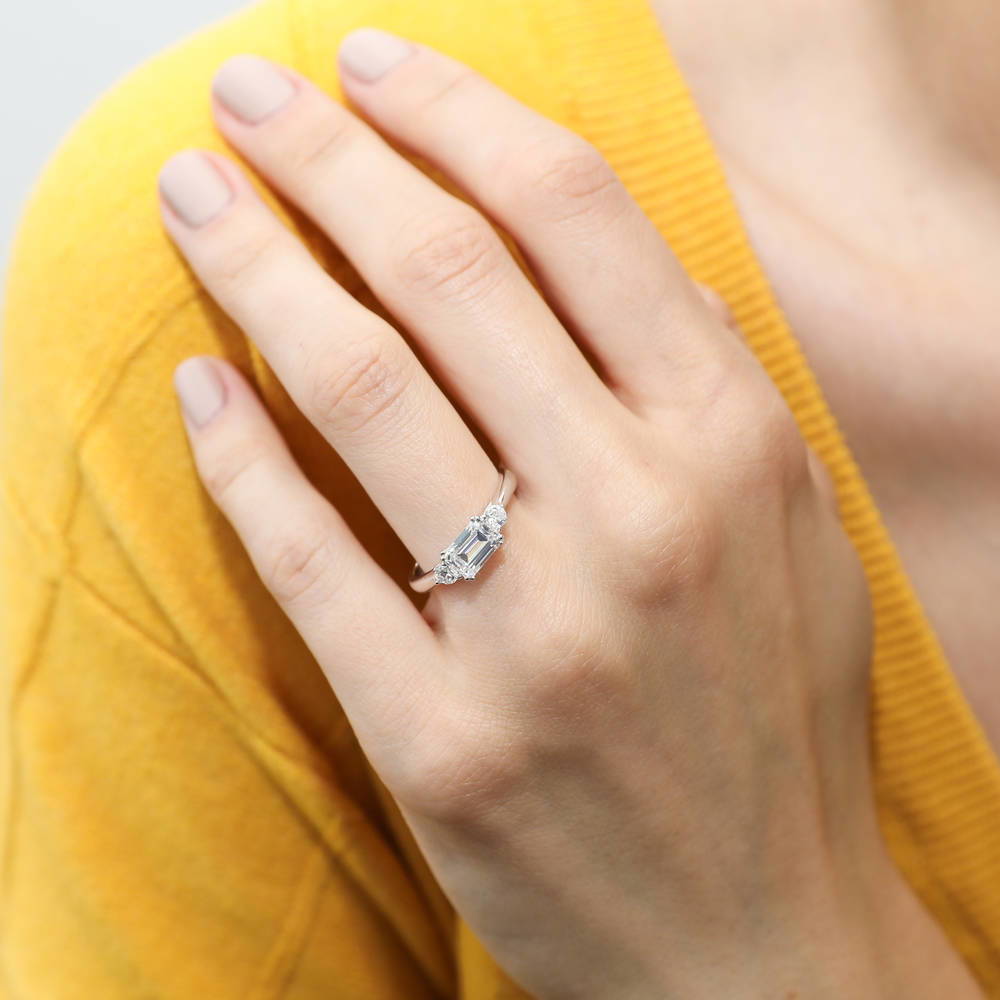 Model wearing 3-Stone East-West 1ct Emerald Cut CZ Ring Set in Sterling Silver, 9 of 12