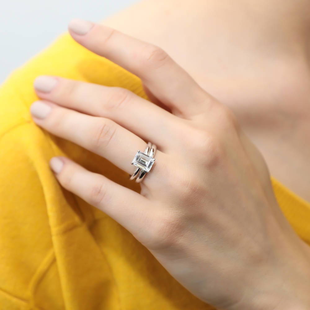 Model wearing Solitaire 2.1ct Emerald Cut CZ Ring Set in Sterling Silver, 2 of 13