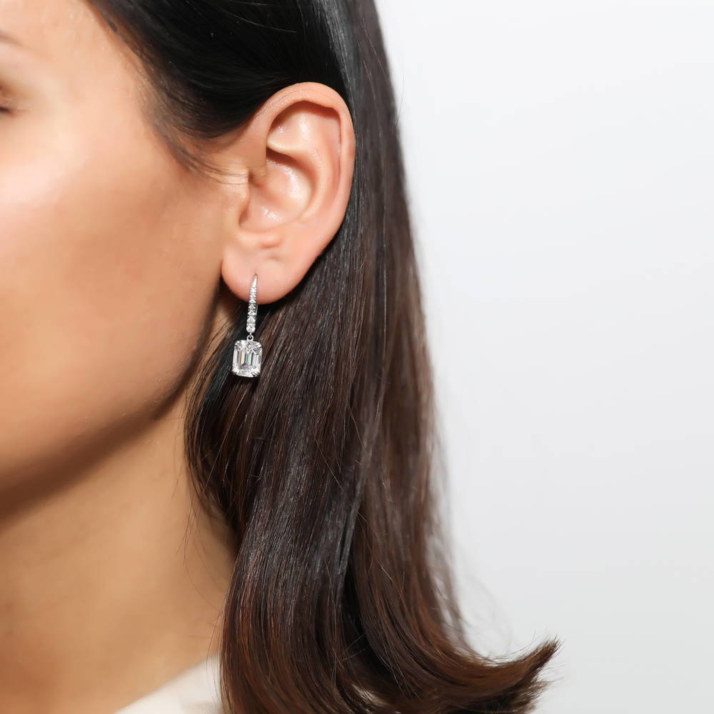 Model wearing Solitaire Emerald Cut CZ Leverback Earrings in Sterling Silver, 2 of 4