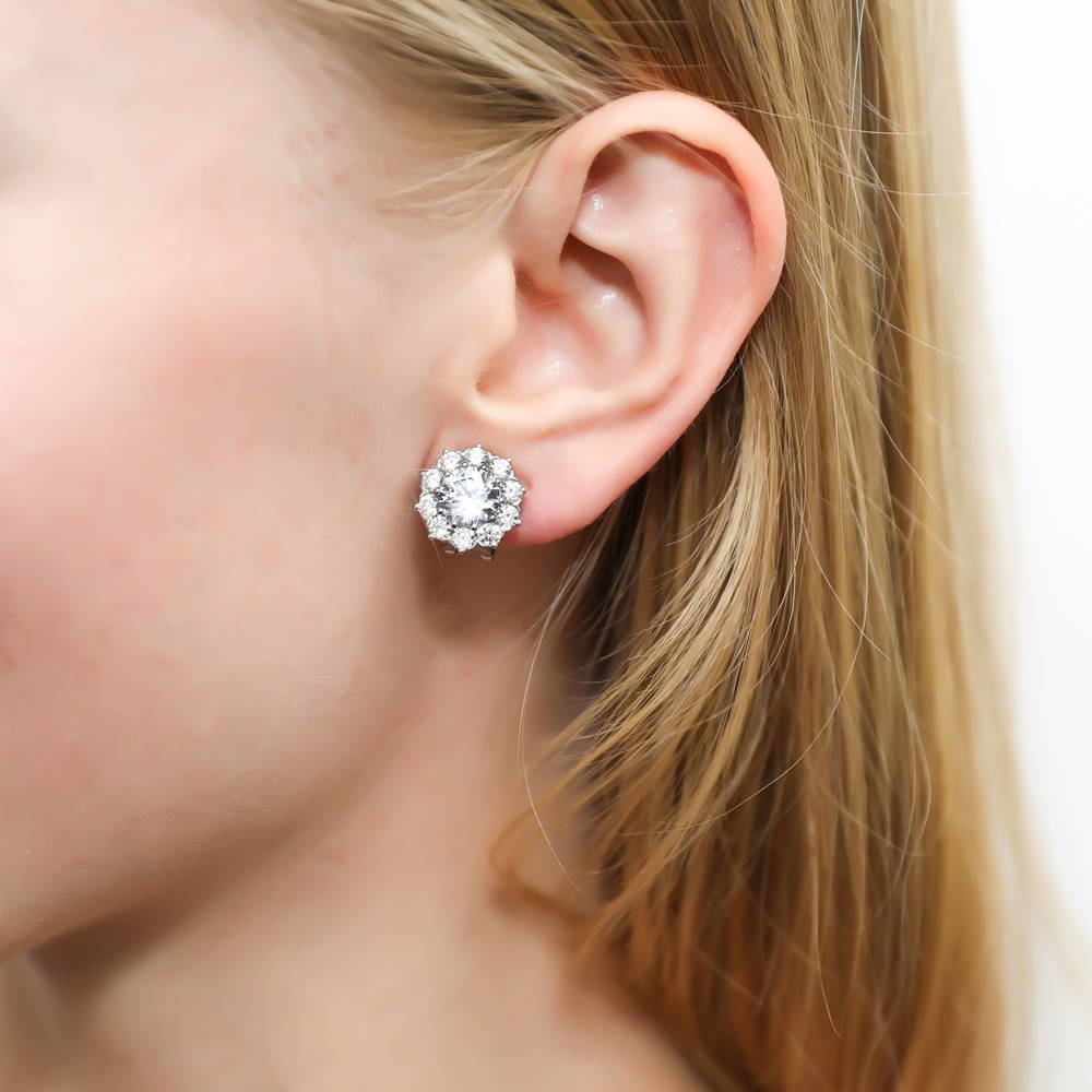 Model wearing Flower Halo CZ Omega Back Stud Earrings in Sterling Silver, 2 of 5