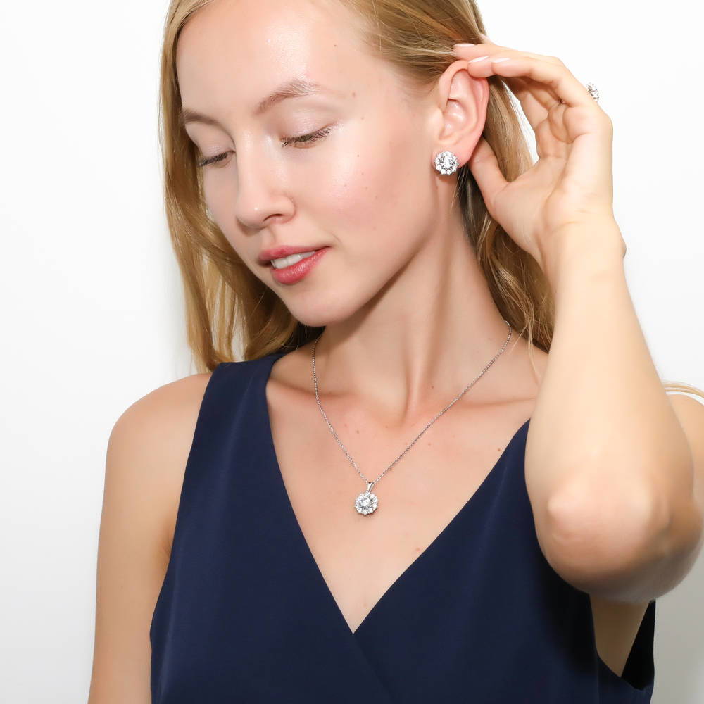 Model wearing Flower Halo CZ Omega Back Stud Earrings in Sterling Silver, 3 of 5