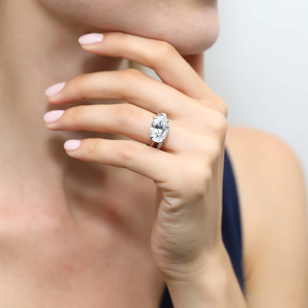 Model wearing Solitaire East-West 5.5ct Oval CZ Ring Set in Sterling Silver, 2 of 13