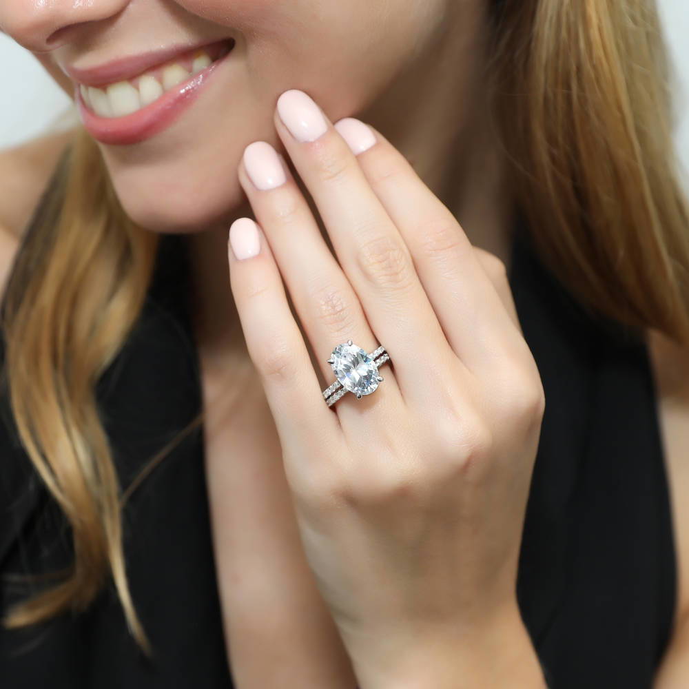 Model wearing Solitaire Hidden Halo 5.5ct Oval CZ Ring Set in Sterling Silver, 2 of 12