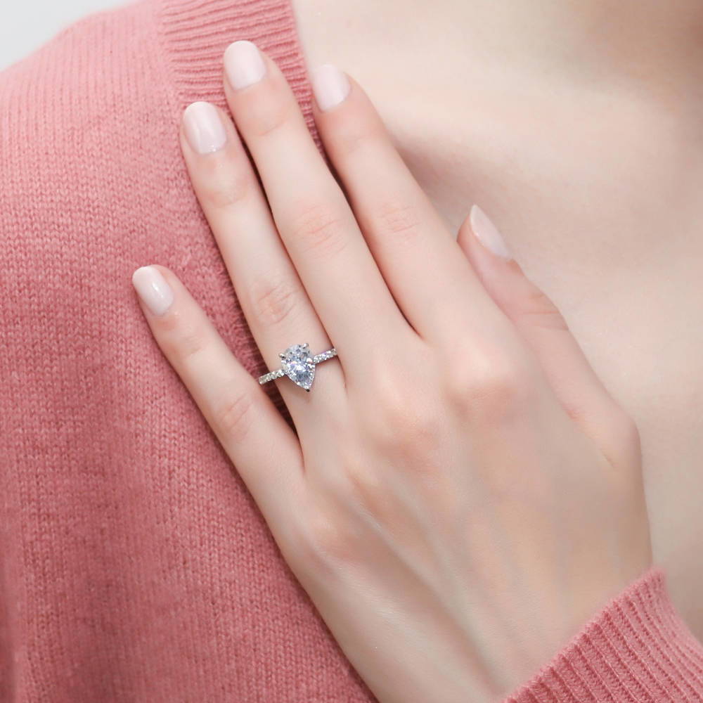 Model wearing Solitaire Hidden Halo 1.8ct Pear CZ Ring Set in Sterling Silver, 9 of 12