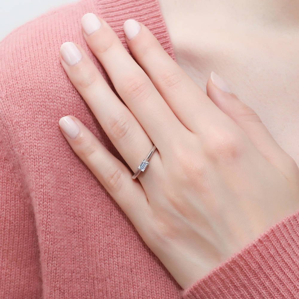 Model wearing Solitaire East-West 0.3ct Emerald Cut CZ Ring in Sterling Silver, 2 of 6