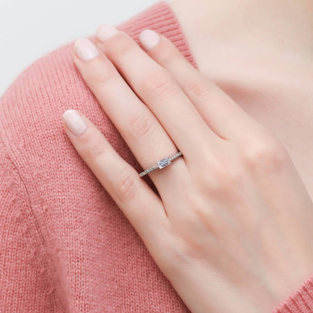 Model wearing Solitaire East-West 0.3ct Emerald Cut CZ Ring in Sterling Silver, 2 of 8