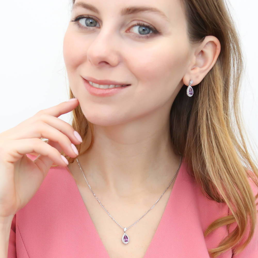 Model wearing Halo Pear CZ Earrings in Sterling Silver, Blue Color