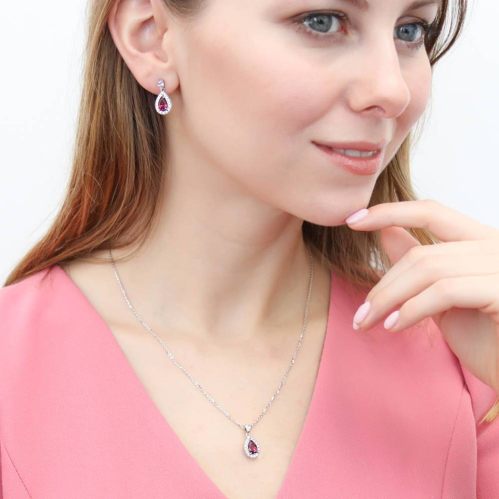Model wearing Halo Pear CZ Earrings in Sterling Silver, Red Color