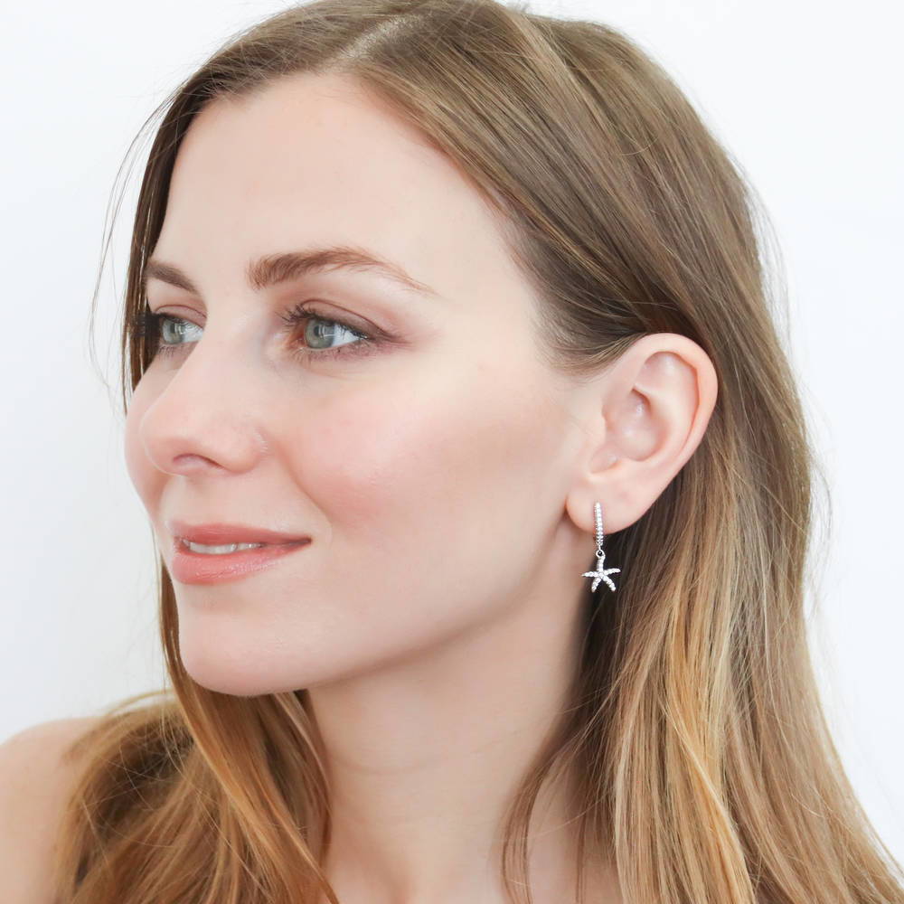 Model wearing Starfish CZ Dangle Earrings in Sterling Silver, 2 of 2