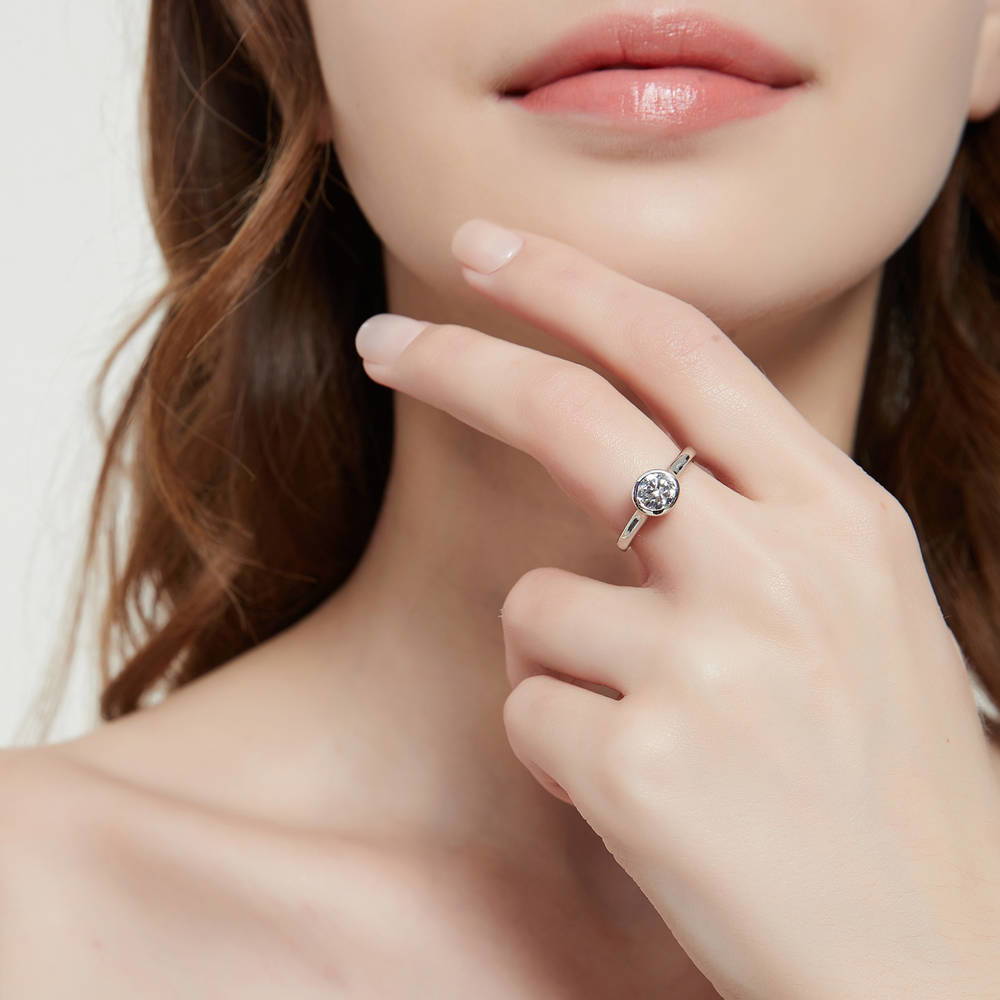 Model wearing Solitaire 0.8ct Bezel Set Round CZ Ring Set in Sterling Silver, 9 of 12