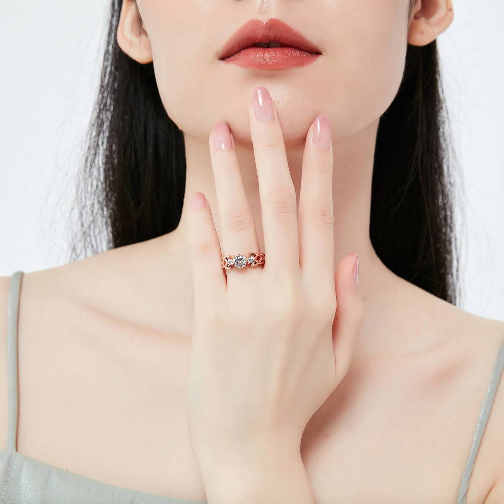 Model wearing Celtic Knot 3-Stone CZ Ring in Rose Gold Plated Sterling Silver, 2 of 7