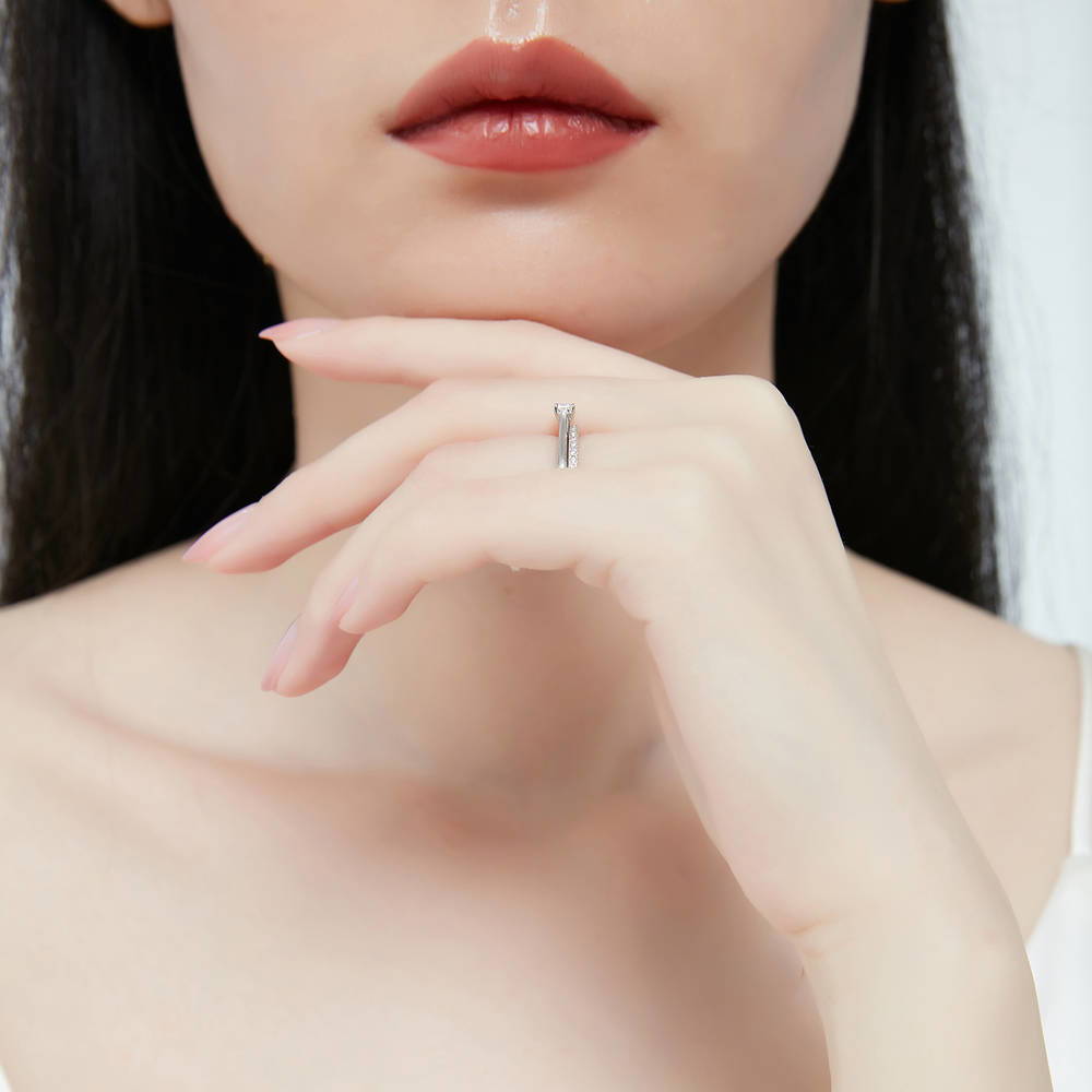 Model wearing Solitaire East-West 0.3ct Emerald Cut CZ Ring in Sterling Silver, 10 of 13