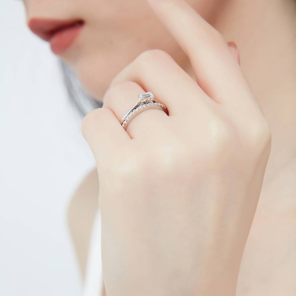Model wearing Solitaire East-West 0.3ct Emerald Cut CZ Ring in Sterling Silver, 9 of 13
