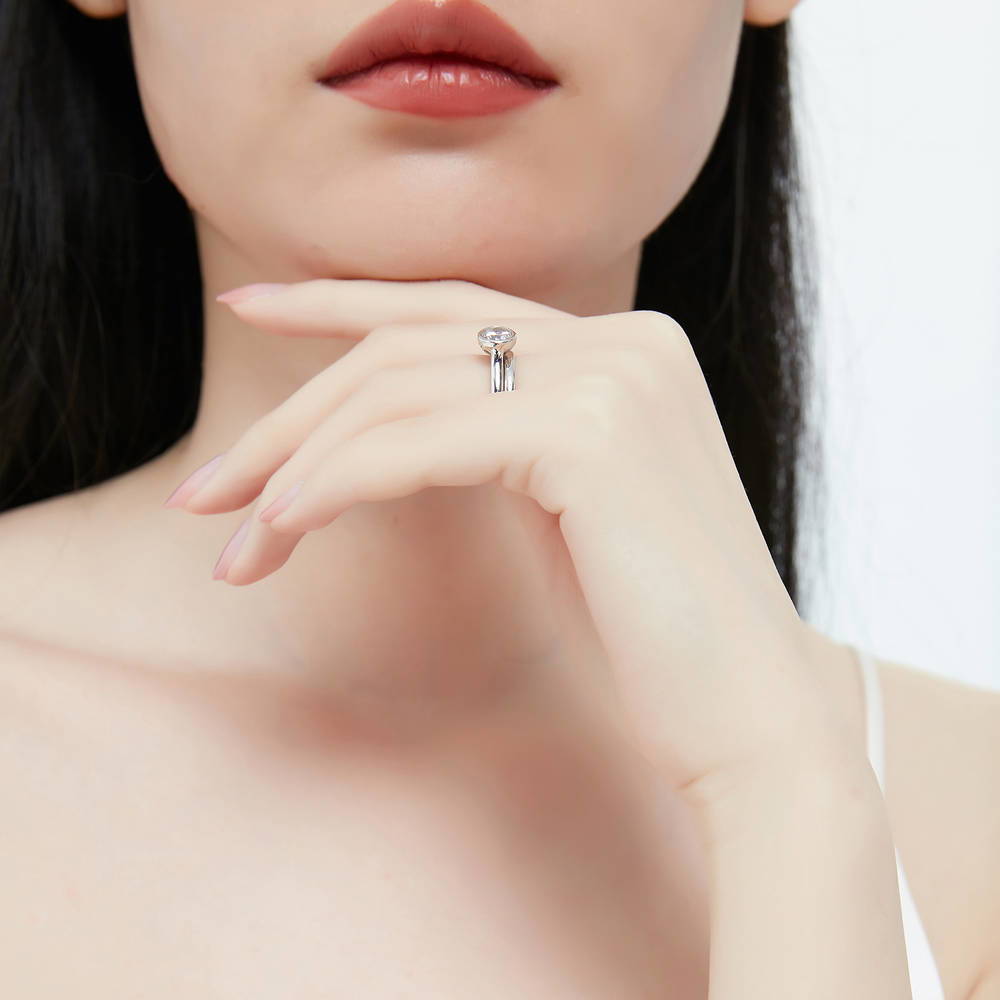 Model wearing Solitaire 0.8ct Bezel Set Round CZ Ring Set in Sterling Silver, 7 of 12