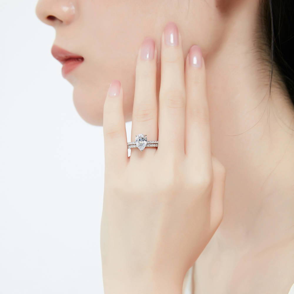 Model wearing Solitaire Hidden Halo 1.8ct Pear CZ Ring Set in Sterling Silver, 2 of 12