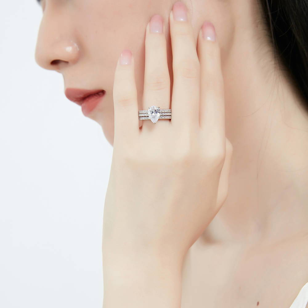 Model wearing Solitaire Hidden Halo 1.8ct Pear CZ Ring Set in Sterling Silver, 2 of 12